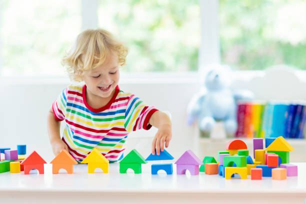 A toddler boy is seen playing with lots of blocks